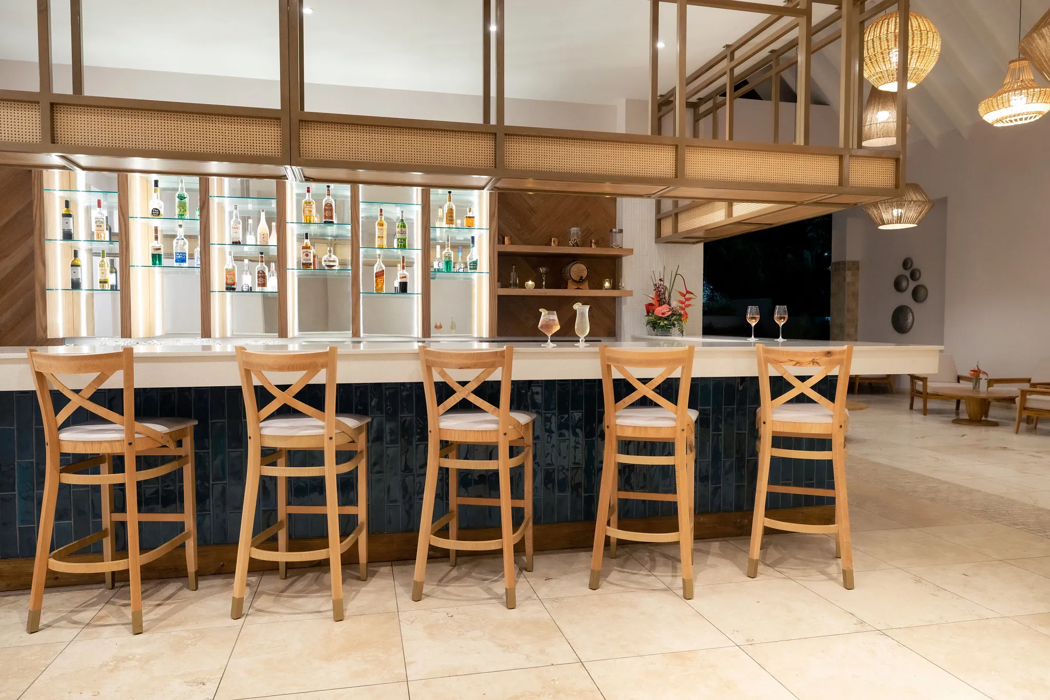 1461 Bar at Zoëtry Marigot Bay St. Lucia featuring a stylish lobby bar with illuminated liquor displays and elegant seating.