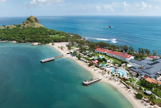 Sandals Grande St. Lucian adults-only all-inclusive resort on Pigeon Island Causeway with overwater bungalows, white sand beach, and Caribbean Sea views.