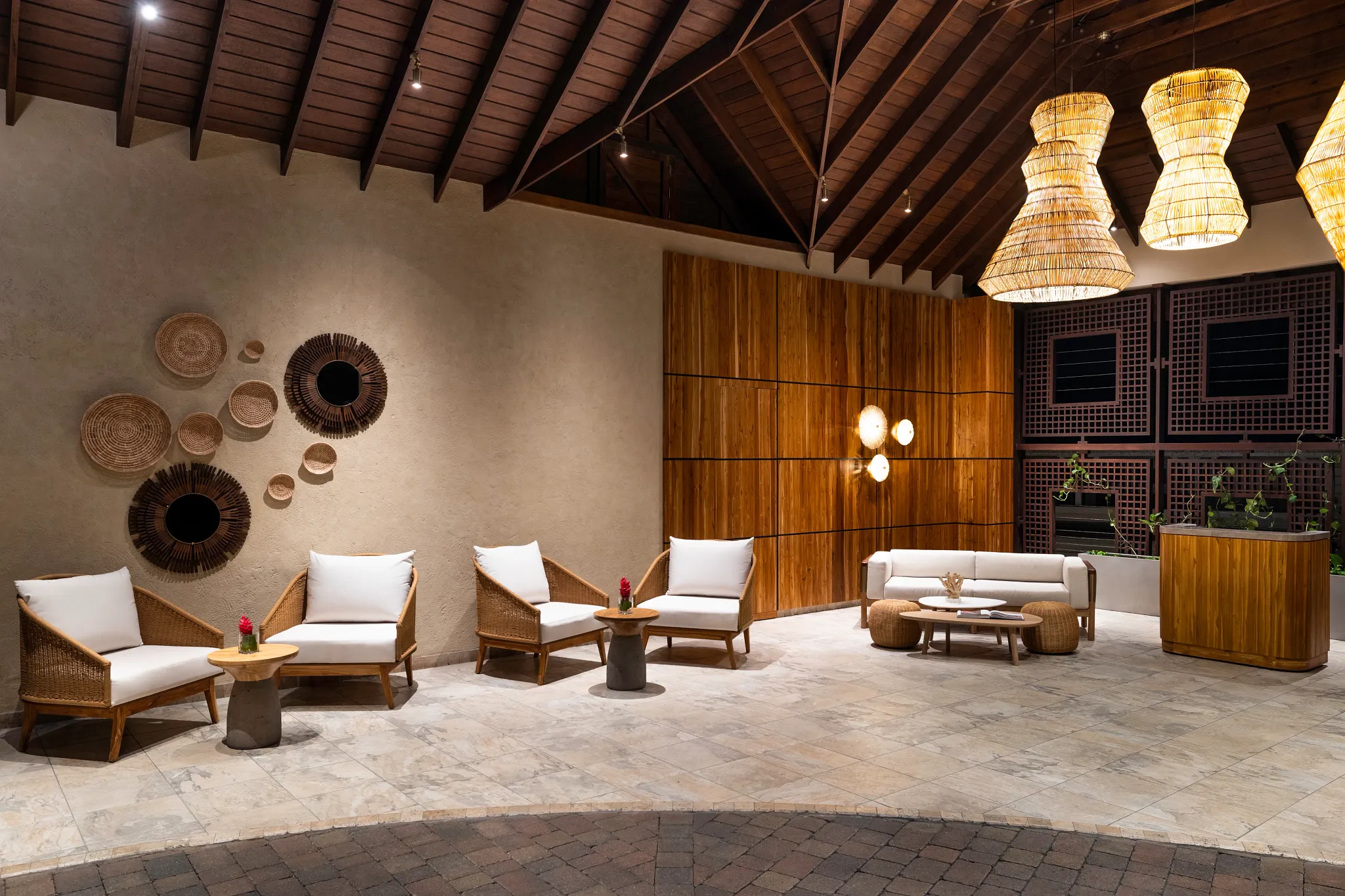 Interior lounge area at Zoëtry Marigot Bay St. Lucia with wooden accents, woven lighting, and comfortable seating.