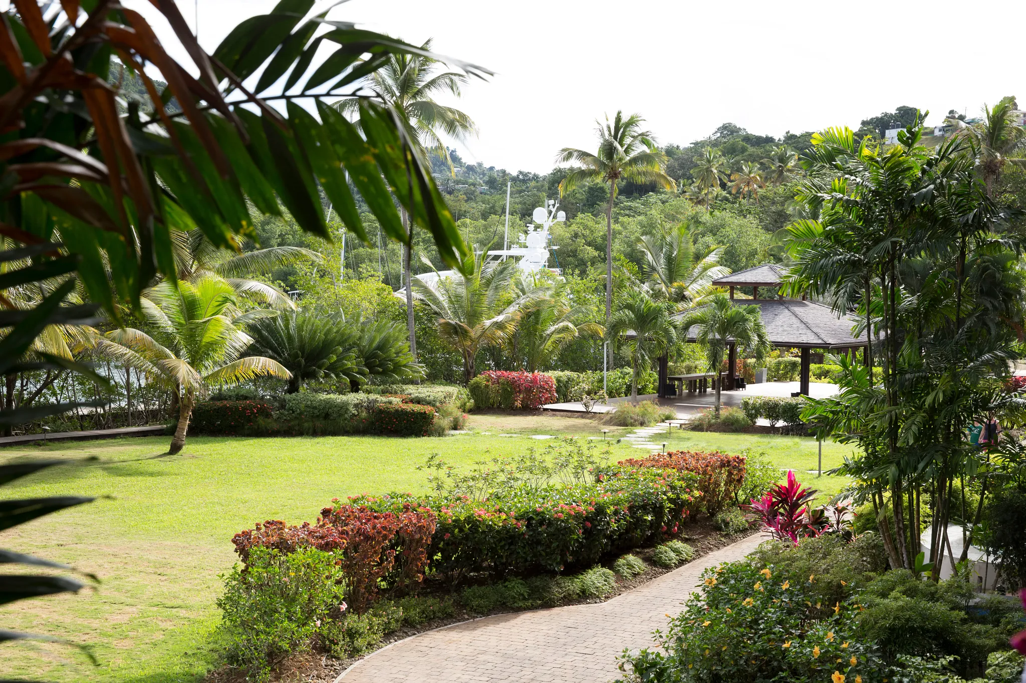 Lush tropical garden with pavilion and palm trees at Zoëtry Marigot Bay St. Lucia.