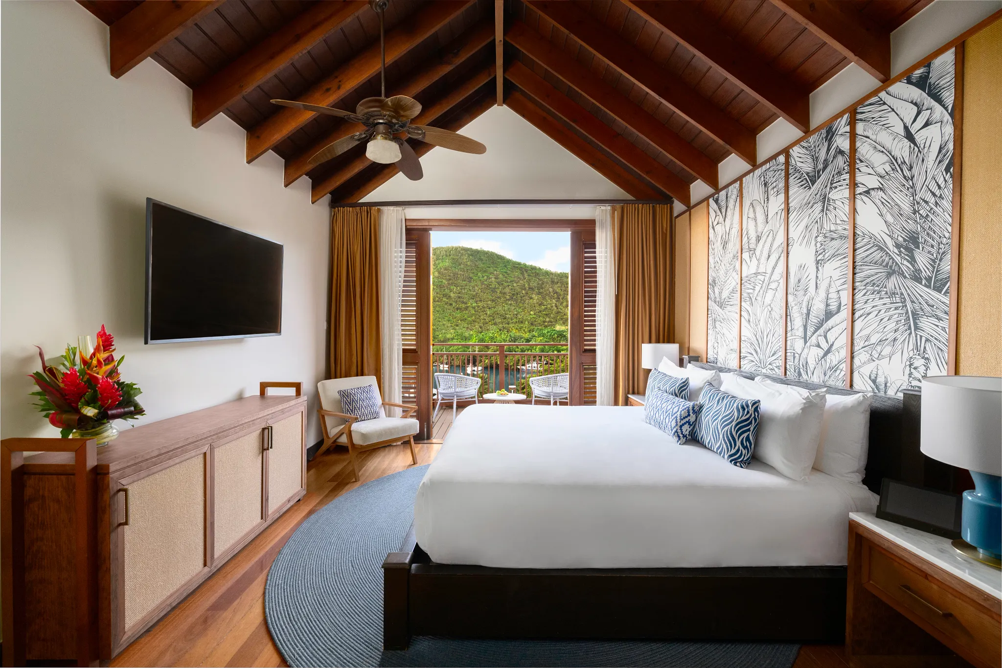 Master bedroom with king bed and balcony at Zoëtry Marigot Bay Penthouse Two Bedroom Residence.